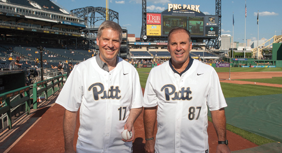 Chancellor Patrick Gallagher (left) threw out the ceremonial first pitch at the July 27 Pirates–Seattle Mariners game at PNC Park. His catcher was none other than Pitt head football coach Pat Narduzzi. Many alumni and their families attended the event, which is sponsored annually by the Pitt Alumni Association. The evening featured a bit of serendipity: beautiful weather, an incredible city view, and an impressive 10-1 Pirates victory. And as the duo posed together for photos, the numbers on their jerseys gave a nod to the University’s founding date of 1787. (Photo by Mike Drazdzinski)