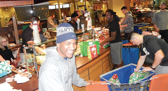 The entire Pitt football team, led by Head Coach Pat Narduzzi, wrapped presents, stuffed gift bags, and sorted packages on Dec. 22 in preparation for the 2015 Christmas Day at Pitt. The free and annual event, held in Litchfield Towers’ Market Central dining space, served more than 2,400 meals to members of the Pittsburgh community in need. Pitt partnered with campus food-services provider Sodexo and the Salvation Army—as well as more than 225 volunteers from Pitt. An additional 134 student athletes volunteered prior to the event, including members of the University’s men and women’s basketball teams, as well as football, swimming and diving, and gymnastics teams.