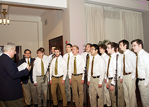 Music Director Richard Teaster (left) and members of the Pitt Men’s Glee Club perform during a recent reception for Chancellor Patrick Gallagher in Alumni Hall (Photo by Emily O'Donnell)