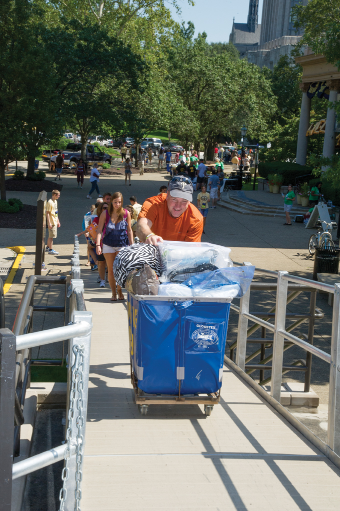 Parents and students make good use of Arrival Survival blue carts on move-in days. 6. Pitt Arrival Survival volunteers help families move boxes near Schenley Quad. 