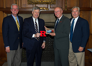 From left, Pitt Athletic Director Steve Pederson and Chancellor Mark A. Nordenberg met July 30 with John Lenkey III, immediate past president of the Rutgers Alumni Club of Pittsburgh, and Eric Young, the current president of the Rutgers alumni club, in the chancellor's Cathedral of Learning office.