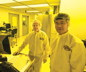 Hrvoje Petek (left) and Hong Koo Kim, codirectors of Pitt’s Petersen Institute for NanoScience and Engineering, are standing in the nanofabrication area of the lab’s “clean room.” The area houses such advanced nanoscale patterning equipment as electron-beam or ion-beam lithography. The process requires an ultraclean environment with a controlled level of air contamination. 