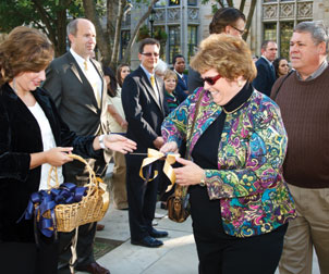 Carol Simko Christobek (ENGR ’77), an ODK awardee, receives her ribbon-cutting scissors for the ceremony. The ODK honor had been given exclusively to male seniors at Pitt for 52 years—becoming known as the “Man of the Year” award—until Christobek won it and received the certificate in 1977. But, alas, the finer text of the award certificate was left unchanged and refers to her “as the senior man of the class of 1977.” Christobek said she still chuckles about the wording, adding that some things never change: When she attended last month’s event with her husband, Mark Christobek (ENGR ’77), some participants incorrectly assumed that he, not she, was the ODK alumnus.