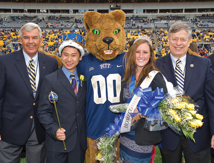 From left, Jack Smith, president of the Pitt Alumni Association; Homecoming King Andrew Kaylor and Homecoming Queen Ainsley Ashton; and Pitt Chancellor Mark A. Nordenberg.