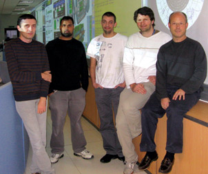 Members of the Pitt team working on the Large Hadron Collider are pictured in the ATLAS experiment control room at the European Organization for Nuclear Research in Geneva, Switzerland. From left, Vakho Tsulaia, graduate student Reza Yoosoofmiya, Thomas Kittelmann, Damien Prieur, and Pitt physics and astronomy professor Joseph Boudreau. Tsulaia, Kittelmann, and Prieur are Pitt postdoctoral researchers.