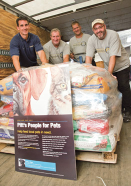 Pitt’s People for Pets campaign, held on the Pittsburgh campus during June and July, generated 4,000 pounds of donated pet food and nearly $2,000 in online cash donations—one of the largest and most successful such drives for Animal Friends’ Chow Wagon program. Animal Friends operates the program to provide donated pet food to the region’s food banks. “The Chow Wagon program keeps pets in the home and tells the pet owners that people care about them,” said Ann Cadman, health and wellness coordinator for Animal Friends. From left, Matt Sloan, Joe Healey, Dave Rahuba, and Dave Huey—all from Pitt’s Department of Parking, Transportation, and Services’ Central Receiving Office—load a pallet of donations for delivery to the Animal Friends shelter in Ohio Township. Officer Riggs, a Labrador Retriever and certified explosives detection specialist for the Pitt Police K-9 Unit, served as the Pitt campaign’s honorary chair and spokesdog. Sponsors of Pitt’s campaign were the Office of the Chancellor, the Office of Community Relations, the Department of Public Safety, and the University Library System.