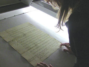 University Library System Associate Katrina Milbrodt scanning a page of the 1787 charter.