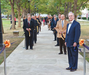 Pitt's ODK honorees, along with several Pitt administrators, stand on the rededicated ODK walkway between Heinz Chapel and the Cathedral of Learning.