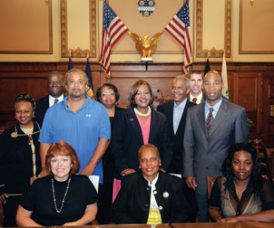 Five members of the Pittsburgh Citizen Police Review Board (CPRB), including Pitt’s Deborah Walker and Debora Whitfield (seated, center and left, respectively), took their oaths of office on Sept. 10 in City Council’s chambers. Walker (CGS ’01, GSPIA ’03), a former Pitt police officer, is the student conduct officer and assistant to the dean in Pitt’s Office of Student Affairs. Whitfield (CGS ’06) is a financial counselor in Pitt’s School of Dental Medicine. Several Pitt administrators and colleagues observed the ceremony. From left, Carol Mohammed, director of Pitt’s Office of Affirmative Action, Diversity, and Inclusion; James N. Williams III, assistant director, City/County Relations, Pitt Governmental Relations; Richard M. Carrington, CPRB member; Gwen Watkins, vice president, Steering Committee, Pitt Staff Association Council; Pitt Vice Provost and Dean of Students Kathy W. Humphrey; Vice Chancellor for Public Affairs Robert Hill; Shawn E. Brooks, associate dean and director, Pitt Residence Life; Eugene M. Downing Jr., CPRB member; and, seated at right, Leshonda Roberts, CPRB member.