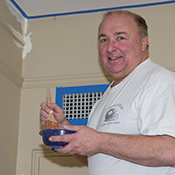 John Kozar, Pitt assistant vice chancellor for human resources, paints at Oakland’s Family House residence facility for patients and their families.
