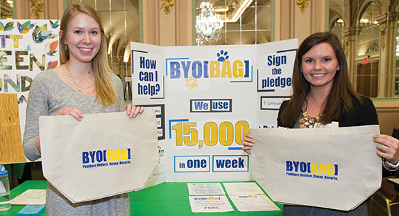Liza Boulet (left) and Jessica McDonald, both graduating environmental studies majors at Pitt, created BYO[BAG], a program intended to reduce plastic bag usage on Pitt’s campus. The program gives each student a 15-bag quota per semester, with usage tracked via a computer system. Once students reach their quota, the bags cost 25 cents each. There has been more than a 70 percent reduction in plastic-bag use on campus since the program began Feb. 3, from 15,000 plastic bags a week to about 4,000 plastic bags.