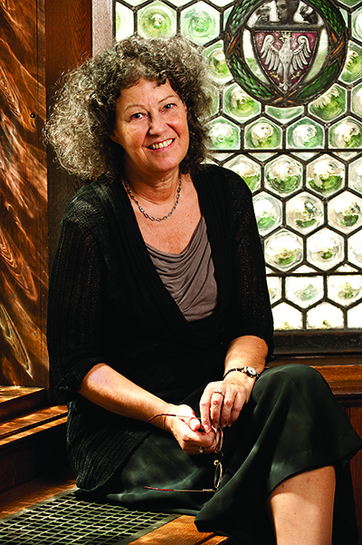 woman sitting in front of a stained glass window