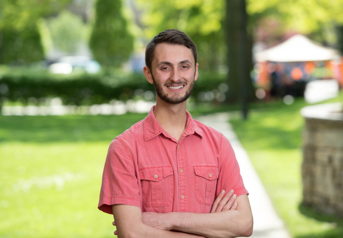 Zachary Grewe in front of a grassy area