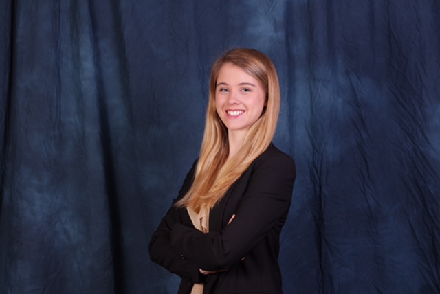 young woman in front of a blue background