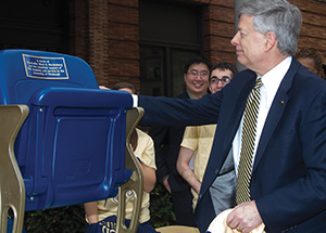 The chancellor is awed by the gift of a blue chair, named in his honor, that will forever sit in the Oakland Zoo section of the Petersen Events Center.