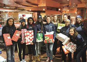 Volunteers gather with presents during last year’s Christmas at Pitt festivities.