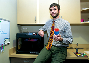 Greg Sciulli, University Store print coordinator, holds a “vase” made by the MakerBot 3-D printer (photo by Tom Altany/Pitt CIDDE)