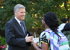 Chancellor Patrick Gallagher speaks with a student