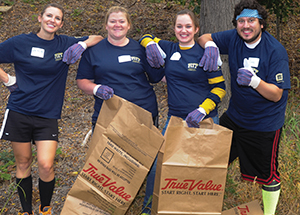 1. Pitt Police Commander Shawn Ellies trims bushes at Peoples Oakland, a nonprofit mental health recovery and wellness center on Bates Street. 2. Mimi Koral, Pitt director of alumni communications, works at the Greater Pittsburgh Community Food Bank in Duquesne. 3. College of General Studies students pulled weeds and prepared the grounds along Bates Street for fall planting