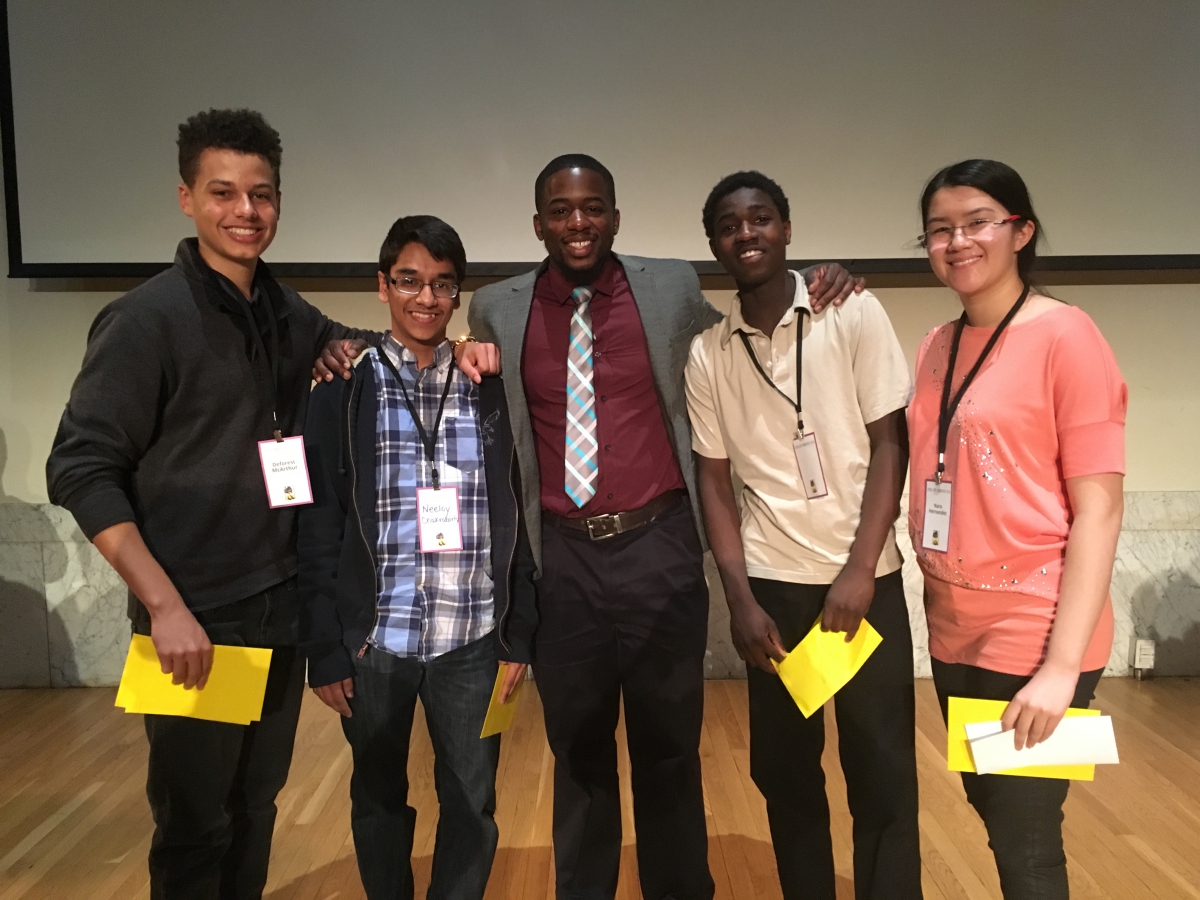 Emiola Jay Oriola (center), associate director of INVESTING NOW, with students at the Steel City Codefest last April. The team competed in the adult level to create a college preparation app for the Homewood Children's Village, a service agency that helps local families. The students won most creative app solution. 