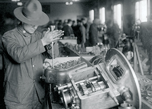 A soldier grinds valves, one of more than 200 distinct skills required to build a Liberty Truck.