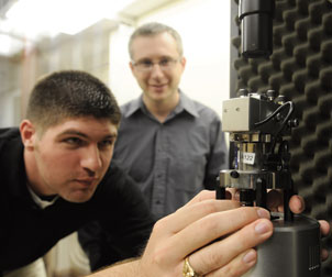 Alexander-Star-Photo#73DA4B Alexander Star (background), an assistant professor of chemistry in Pitt's School of Arts & Sciences, is working with other researchers in his lab to turn nanotubes into chemical and biological sensors. His research group recently used tubes with diameters 100,000 times smaller than a human hair to develop a sensor that can warn asthma sufferers of an impending attack. Here, Brett Allen, who recently completed his doctoral degree in chemistry under Star’s supervision, uses an atomic force microscope to visualize carbon nanotubes.