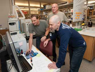 Bruce Freeman (middle, standing), the UPMC Irwin Fridovich Professor and chair of the Department of Pharmacology and Chemical Biology in Pitt’s School of Medicine, discovered nitro-fatty acid derivatives that may have applications as a drug to treat diabetes and metabolic and inflammatory diseases. He has launched a pharmaceutical startup company through the Pittsburgh Life Sciences Greenhouse to license the University patents and conduct human clinical trials. From left, Francisco Schopfer, a research assistant professor; Freeman; and Gustavo Bonacci, an instructor in the Department of Pharmacology and Chemical Biology.