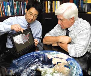 Computer modeling can show how disease spreads through whole populations. Donald Burke (right), dean of Pitt’s Graduate School of Public Health and the UPMC-Jonas Salk Chair of Global Health, is a pioneer in using computer modeling to understand the behavior of pandemic disease. Burke and Bruce Lee, an assistant professor in GSPH and a core member of the recently founded Public Health Dynamics Laboratory, examine a map showing the spread of influenza throughout the United States.