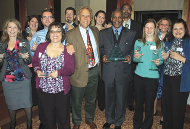 Pitt’s Office of Public Affairs received 23 awards—including Best in Show for the Newspaper of Record: The Pittsburgh Courier, 1907-1965 project—during the International Association of Business Communicators awards ceremony on Sept. 30. Front row, from left: Terry Capp (in purple sweater), University Marketing and Communications (UMC) director of publications and marketing; Dave Crawley, KDKA-TV reporter and the evening’s master of ceremonies; Pitt Vice Chancellor for Public Affairs Robert Hill; Cara Masset, senior editor, Pitt Magazine; and Susan Tresatti, UMC Web producer. Back row, from left: Debra McCluskey, UMC Web producer; Amy Porta Kleebank, UMC art director; Randy Oest, UMC Web designer; Don Henderson, UMC assistant creative director; Sarah Nelsen, UMC art director; Ervin Dyer, senior editor, Pitt Magazine; and Rainey Opperman-Dermond, UMC art director.