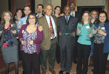 IABC-award-photo Pitt’s Office of Public Affairs received 23 awards—including Best in Show for the Newspaper of Record: The Pittsburgh Courier, 1907-1965 project—during the International Association of Business Communicators awards ceremony on Sept. 30. Front row, from left: Terry Capp (in purple sweater), University Marketing and Communications (UMC) director of publications and marketing; Dave Crawley, KDKA-TV reporter and the evening’s master of ceremonies; Pitt Vice Chancellor for Public Affairs Robert Hill; Cara Masset, senior editor, Pitt Magazine; and Susan Tresatti, UMC Web producer. Back row, from left: Debra McCluskey, UMC Web producer; Amy Porta Kleebank, UMC art director; Randy Oest, UMC Web designer; Don Henderson, UMC assistant creative director; Sarah Nelsen, UMC art director; Ervin Dyer, senior editor, Pitt Magazine; and Rainey Opperman-Dermond, UMC art director.