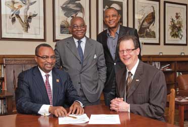  Robert O. Agbede (ENGR ’79, ’81G), president and CEO of Chester Engineers Inc., in Moon Township, pledged $50,000 to support a need-based scholarship for students from underrepresented groups—including African Americans and African émigrés—aspiring to the STEM (science, technology, engineering, and mathematics) fields. Agbede developed the fund to mark the 100th anniversary of Chester Engineers, which he acquired in 2003 and transformed into the largest Black-owned environmental engineering firm in the United States. The scholarship continues his dedication to paying forward the financial support he received as a young Nigerian immigrant pursuing a career in engineering. His company also supports the ACS-Chester Engineers Scholarship, an endowed gift established in 1944 that is currently worth $1.3 million. A May 18 pledging ceremony at Pitt’s University Club included Agbede (left, seated); Pitt Vice Chancellor for Institutional Advancement Albert J. Novak Jr. (right, seated); Akin Iroko (right, standing), CEO of TVL Consulting Limited, a Nigerian strategic management firm; and Emmanuel Chike Nwanze (left, standing), current president of the Institute of Directors, a Nigerian business organization, and CEO of Icon Stockbrokers Limited in Nigeria. Nwanze and Iroko were part of a Nigerian delegation participating in a weeklong program on leadership, ethics, and corporate governance hosted by GSPIA’s Johnson Institute for Responsible Leadership.