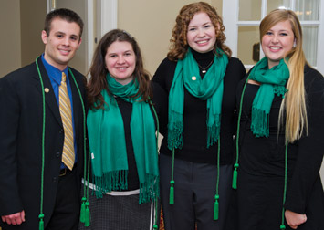 The green cords of distinction worn by some Pitt graduates today indicate completion of the University’s Outside the Classroom Curriculum (OCC). OCC began at Pitt in 2008 as an initiative to help students fully participate in college life and prepare for their futures. A wide range of activities earns OCC credits, and students’ participation is documented on their academic transcripts. Once a student has fulfilled the OCC requirements, he or she receives a green cord of distinction for commencement and, if desired, can seek induction into the Honorary Society. About 285 students have completed the curriculum this year, 206 of whom have been inducted into the Honorary Society. An estimated 183 seniors have earned their cords of green, which represent Pitt’s colors, blue and gold, blended to symbolize the education of the whole student. Pictured, from left, are OCC Honorary Society officers  and graduating seniors Mark Hennessy, vice president of membership; Samantha Bertocchi, secretary; Glyn Cozart, president; and Britta Anderson, vice president of programs. Not pictured is Emily Hoover, business manager.