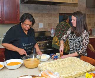 SAC-Family-House-dinner-024146_001_DIG_DSC_4254_00 Seven members of Pitt's Staff Association Council (SAC) served dinner on Dec. 10 to residents of Family House, located on the upper floors of the University Club, one of four locations for the nonprofit organization that provides affordable housing for out-of-town, critically ill patients and their families. Pictured from left are Gwen Watkins, SAC president and the community activities coordinator in Pitt's Office of Community and Governmental Affairs, and Monica Costlaw, chair of SAC's programs and planning committee, which arranged the event. Costlaw is a senior Medicaid policy analyst in Pitt's Graduate School of Public Health's (GSPH) Department of Health Policy and Management, as well as a GSPH student.
