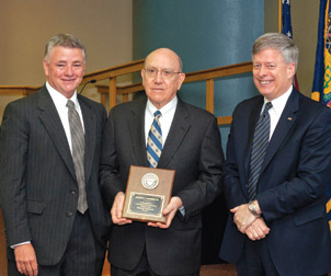 During its June 24 meeting, Pitt’s Board of Trustees recognized George Davidson (center) for his board service, which began in 1987, and named Davidson an emeritus trustee. Standing with him are Stephen Tritch (left), board chair, and Pitt Chancellor Mark A. Nordenberg.