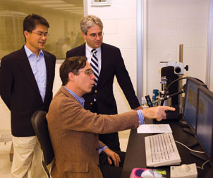 Waldeck,-Geller,-Kim Pitt’s David Waldeck (seated) works with Hong Koo Kim (standing left), and David Geller, the Richard L. Simmons Professor of Surgery in Pitt’s School of Medicine and codirector of the UPMC Liver Cancer Center. Waldeck’s research is focused on finding a way to use nanoparticles to make a commercially viable photovoltaic paint that can convert sunlight into electricity. Waldeck is a professor of chemistry and chair of the Department of Chemistry in the School of Arts and Sciences.