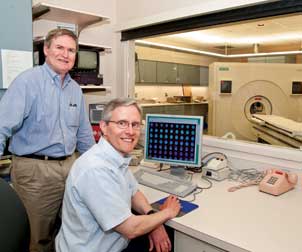 Chester A. Mathis (standing), professor and director of the PET Facility in the Department of Radiology, and William E. Klunk, professor of psychiatry, developed Pittsburgh Compound B (PiB), perhaps the most significant diagnostic advance in Alzheimer’s research today. PiB allows clinicians to see amyloid plaques in the living brain of individuals with Alzheimer’s and also in those who do not yet exhibit signs of the disease. This finding could lead to earlier diagnosis, illuminate disease progression, and uncover prevention strategies.