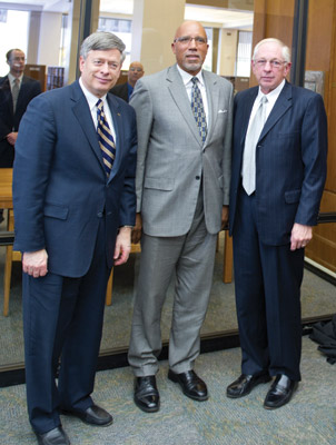 An interactive display showing the Gold Medal won by University of Pittsburgh alumnus and track star John Woodruff at the 1936 Olympic Games in Berlin was unveiled Oct. 14 on the first floor of Pitt’s Hillman Library. University Library System Director and Hillman Librarian Rush Miller and Pitt Vice Chancellor for Public Affairs Robert Hill hosted the event; Chancellor Mark A. Nordenberg and other Pitt officials delivered remarks. From left, Chancellor Nordenberg; John Woodruff Jr., a New York City attorney; and Miller.