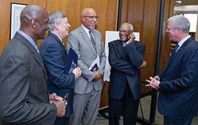 Woodruff-Display#8 From left, Alonzo Webb, head coach of Pitt's Track and Field team; Chancellor Nordenberg; Woodruff Jr.; Pitt trustee Herbert P. Douglas Jr. (EDUC ’48, ’50G), a bronze medalist in the long jump at the 1948 Olympics; and Steve Pederson, Pitt athletic director.