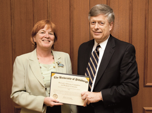 Chancellor Mark A. Nordenberg presented the 2009 Affirmative Action Award to the Provost’s Advisory Committee on Women’s Concerns (PACWC). The honor is presented annually to an “outstanding University program area or individual that has made a significant contribution in affirmative action.” Accepting the award on behalf of the committee’s 19 members is Patricia Beeson, PACWC chair and Pitt vice provost for graduate and undergraduate studies. The award was presented during a June 10 University Senate Council meeting.