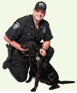 backcov2 The University has launched a new program, Pitt’s People for Pets, to help local families who, because of tough economic times, are unable to feed their beloved pets. During June and July, Pitt will participate in Animal Friends’ Chow Wagon, which provides pet food to area food banks to ensure that pets and their families can remain together. Pitt Police Department Officer Riggs (below, four legs, wearing leash) has agreed to serve as the Pitt drive’s honorary chair; he poses with his partner, Officer David Nanz, for a publicity photo. Pitt sponsors are Office of the Chancellor, Office of Community Relations, Department of Public Safety, and the University Library System. Online monetary donations can be made by visiting <a href=
