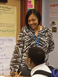 Carlena Gatewood works with a student in her classroom at University Prep in the Hill District.