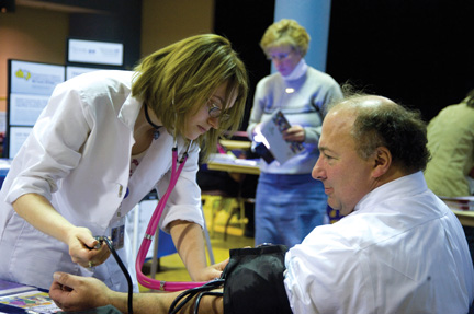 Spring Into a Healthy Lifestyle was the theme of an April 14 health fair sponsored by Pitt’s Staff Association Council in the William Pitt Union. Vendors included Venture Outdoors, the University benefits department, Falk Pharmacy, the Central Blood Bank, and others. Above, John Kozar, Pitt director of benefits, has his blood pressure taken during the fair.