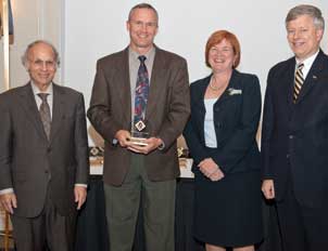 CELEBRATING INNOVATION AT PITT: William Clark (second from left), a University of Pittsburgh professor of mechanical engineering and materials science, received a Pitt Innovator Award during the University’s 2010 Celebration of Innovation Oct. 5 at the University Club. The sixth annual celebration, hosted by the Office of the Provost and Office of Technology Management, honored researchers at Pitt who, during the past year, have developed innovations with commercial potential. Of those researchers, 72 received Innovator Awards during the evening for their innovations that have been licensed or optioned to industry. Clark was part of a Pitt team that developed a device that gives cardiac patients early warning of even the slightest of heart attacks. The device, which comprises two Pitt innovations, was optioned recently to a start-up company called Telecardia. Also pictured (from left) are Arthur S. Levine, dean of Pitt’s School of Medicine and senior vice chancellor for the health sciences; Patricia E. Beeson, Pitt provost and senior vice chancellor; and Pitt Chancellor Mark A. Nordenberg.