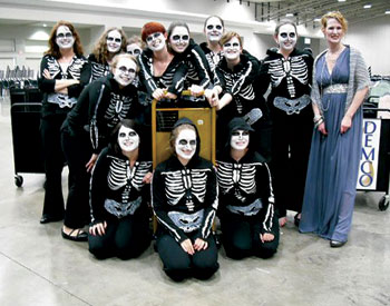 library-photo-page-10 Students from Pitt’s School of Information Sciences (SIS) summoned a spirited performance set to the music of Camille Saint-Saëns’ Danse Macabre and departed the 6th Book Cart Drill Team World Championships with the coveted first-place prize, the Golden Book Cart. The event was staged June 27 during the American Library Association’s 2010 conference in Washington, D.C. The skeleton crew of 13 students presented Night of the Living Librarians, a book-cart ballet arranged by team captain and SIS graduate student Sherri Griscavage that complemented Saint-Saëns’ ghoulish musical score with visual themes and recorded excerpts from English author Neil Gaiman’s novel The Graveyard Book. The performance can be viewed on YouTube at http://www.youtube.com/watch?v=NUlVQm0Whc4.