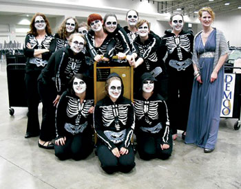 Students from Pitt’s School of Information Sciences (SIS) summoned a spirited performance set to the music of Camille Saint-Saëns’ Danse Macabre and departed the 6th Book Cart Drill Team World Championships with the coveted first-place prize, the Golden Book Cart. The event was staged June 27 during the American Library Association’s 2010 conference in Washington, D.C. The skeleton crew of 13 students presented Night of the Living Librarians, a book-cart ballet arranged by team captain and SIS graduate student Sherri Griscavage that complemented Saint-Saëns’ ghoulish musical score with visual themes and recorded excerpts from English author Neil Gaiman’s novel The Graveyard Book. The performance can be viewed on YouTube at http://www.youtube.com/watch?v=NUlVQm0Whc4.