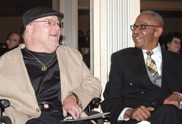 Hill (right) talks with Ron Flynn, who had volunteered to be a recipient of the Salk vaccine in its experimental phase even though he could not benefit directly from the inoculation because he had already contracted polio.
