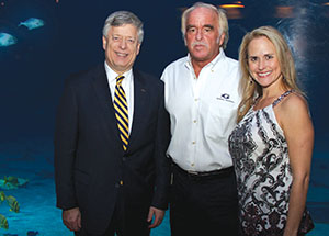 Chancellor Mark A. Nordenberg (left) with Gregory and Jennifer Bossart. Alumnus Gregory Bossart —chief veterinary officer and senior vice president of Veterinary Services at the Georgia Aquarium—hosted the Chancellor along with Pitt Alumni Association leaders, members, and staff at the University on the Road reception.